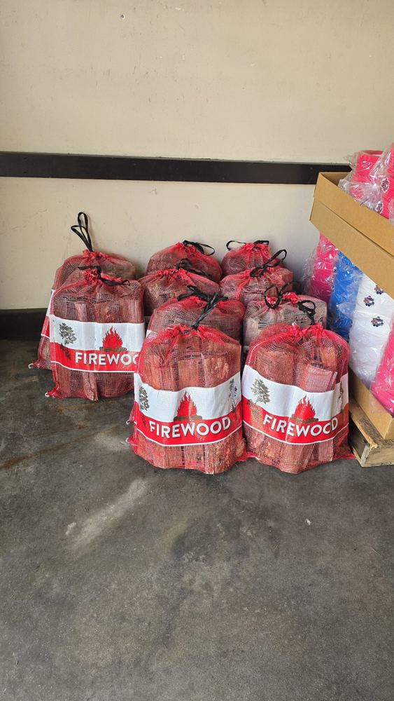 KIR firewood bundle bags stacked and ready — $7 each or 3 for $20